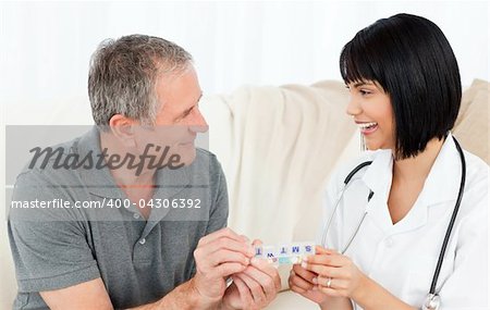 Nurse showing pills to her patient