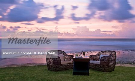 Romantic dinner on the ocean coast at sunset