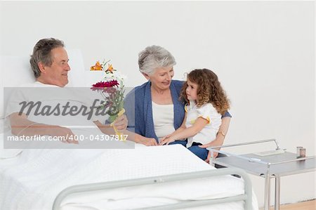 A little girl talking with her grandparents in a hospital