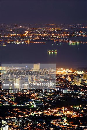 City night with golden buildings in Penang, Malaysia, Asia.