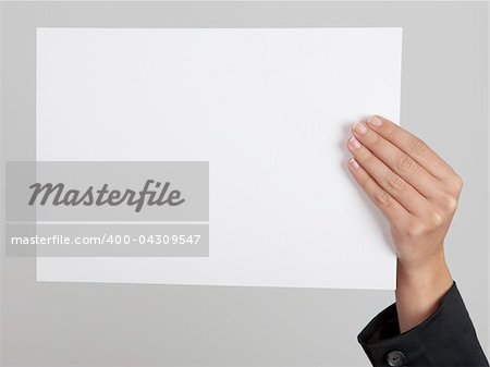 Female hand holding a blank paper sheet