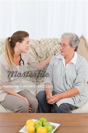 Nurse talking with her patient at home