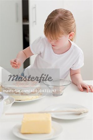 Adorable girl baking in her kitchen at home