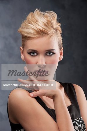 beauty young blond woman with creative hair style and fashion make up looking