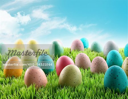 Colorful Easter eggs in a field of grass with blue sky