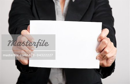 Woman holding a blank paper sheet with both hands