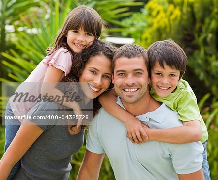 Parents giving children a piggyback