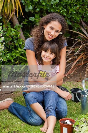 Portrait of a joyful mother with her daughter in the garden