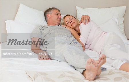 Beautiful couple sleeping on their bed