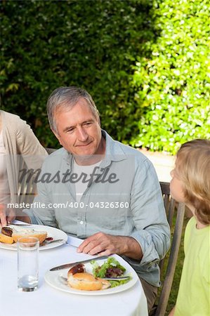 Adorable family eating in the garden