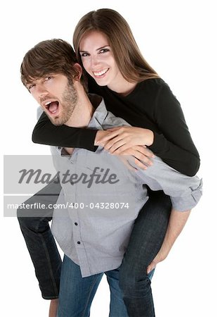 Young handsome man carries a cute lady on his back