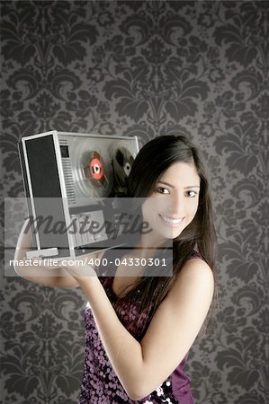 Retro open reel tape recorder beautiful brunette Dj hearing music gray walpaper