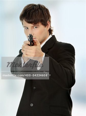 Businessman aiming with handgun.