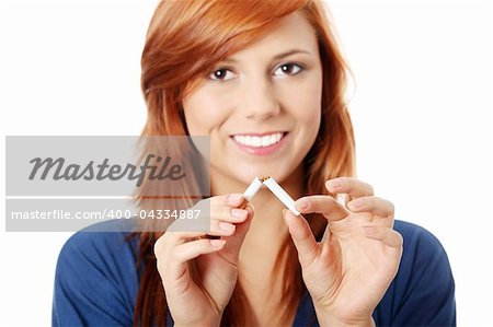 Young happy woman breaking cigarette, over white background