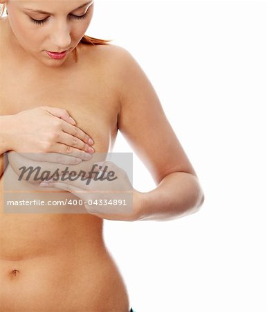 Young caucasian adult woman examining her breast for lumps or signs of breast cancer