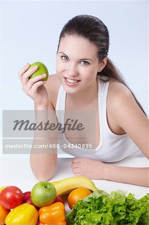 Attractive girl with fruits and vegetables on white background