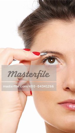 A picture of a beautiful woman plucking her eyebrow over white background