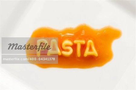 pasta spelt with spaghetti letters on a white square plate