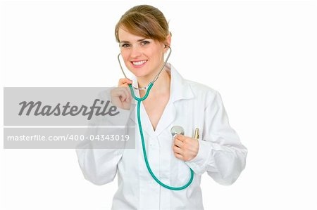 Smiling  doctor woman listening to her heart with stethoscope isolated on white