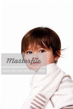 Face of a cute adorable baby infant toddler with innocent surprised expression looking over shoulder, isolated.