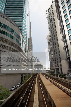 City scenery with railroad over business skyscraper.