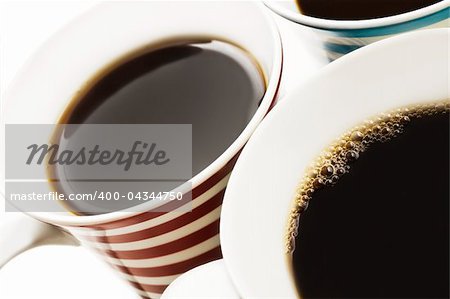 Close ups of mugs of black coffee