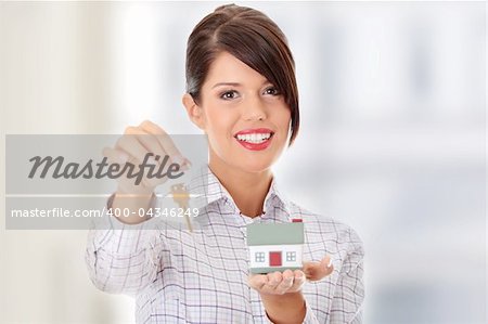 Young businesswoman  (real estate agent) with hose model and keys