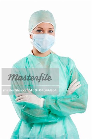 young beauty nurse in green operation dress with surgery cap and mask posing