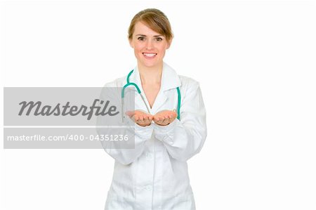Smiling female medical doctor presenting something on empty hands isolated on white