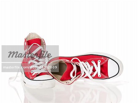 Vintage red shoes relaxed on pure white background