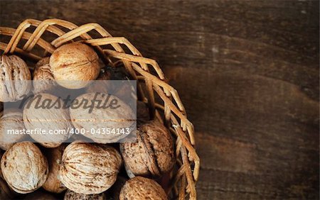 walnuts in the basket on wooden plank