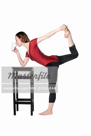 Slim woman drinking tea and stretching at the same time