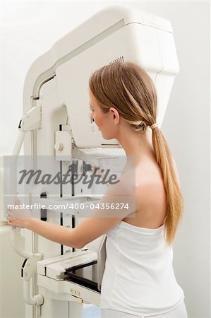 A woman taking a Mammogram test in a hospital