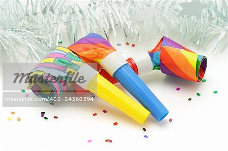 Three colorful paper party blowers or nosiemaker