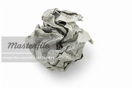 Crumpled newspaper in shape of ball on white background