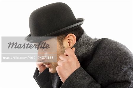 Portrait of a man with bowler hat  hiding from the cold