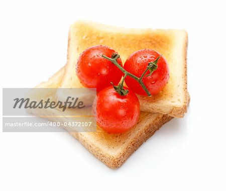Two pieces of toast on the table with tomatoes
