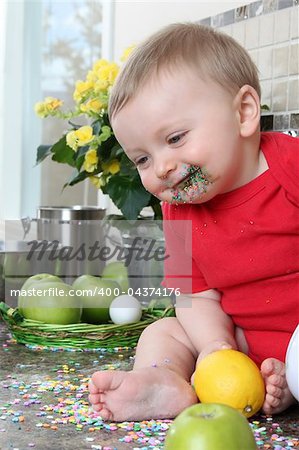 Baby boy playing on messy counter top