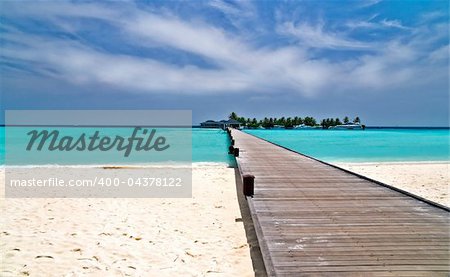 footbridge over turquoise ocean on an maldivian island