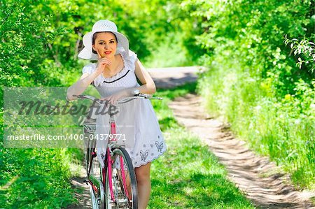 Young woman with a vintage bicycle