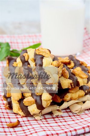 homemade cookies with chocolate and nuts and a glass of milk