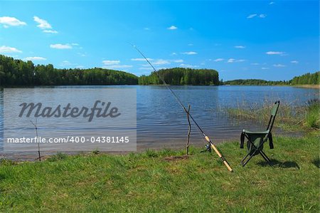 Fishing rod and folding chair by the lake