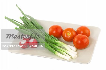 white plate with tomato, radish and green onion, vegetarian food
