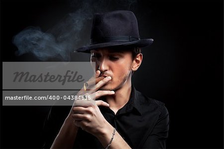 Gangster look. Handsome man with hat and cigar.