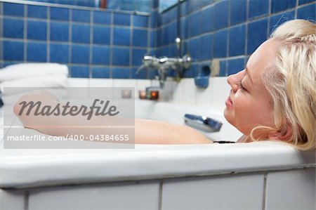 An attractive blonde woman relaxing in spa bath