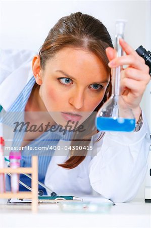 Pensive doctor woman in laboratory analyzing results of medical test