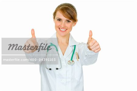 Smiling medical doctor woman showing thumbs up gesture isolated on white