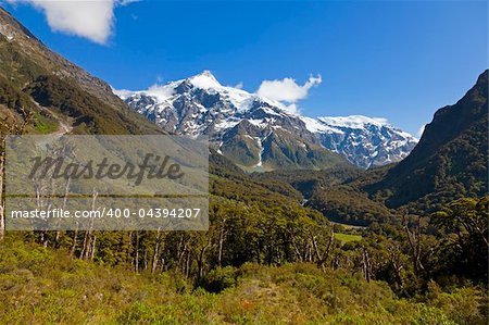 View from the valley towards snow capped peaks in New Zealand