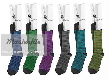 Row of socks on pegs on a white background