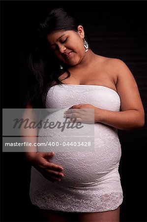 beautiful latin woman pregnant, isolated on black, studio shot